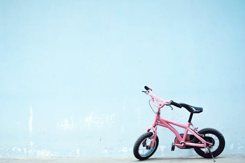 Toddler's Pink Bike Near Wall