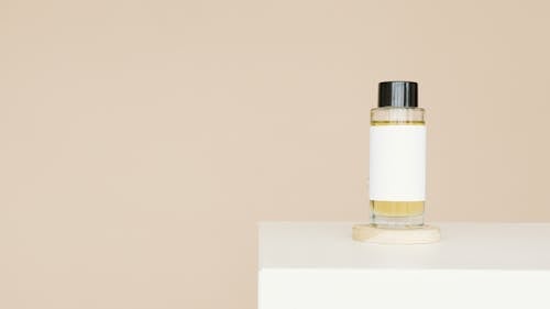 Free White and Gold Bottle on White Table Stock Photo