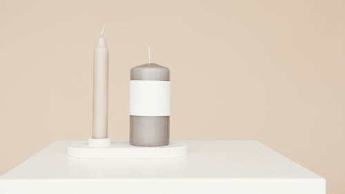 Candles on White Table Near Beige Wall