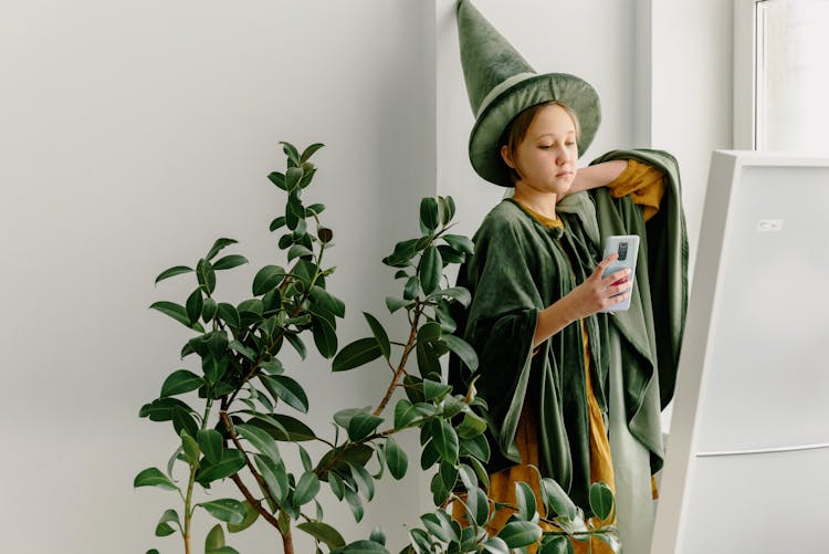 Young Girl Wearing Green Costume Taking Video