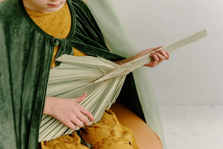 A Young Girl Holding A Branch Of Palm