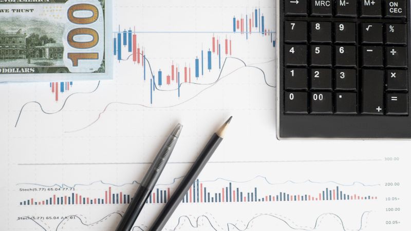 Stock analysis workspace featuring charts, a calculator, and currency for data-driven insights.
