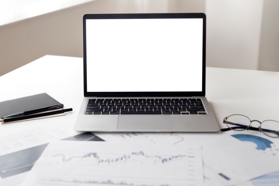 Laptop with financial and marketing charts, representing Etsy SEO listing strategy to rank number one