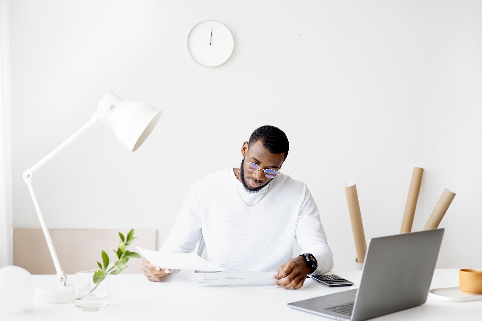 Small business owner using a laptop to explore AI automation tools at their desk