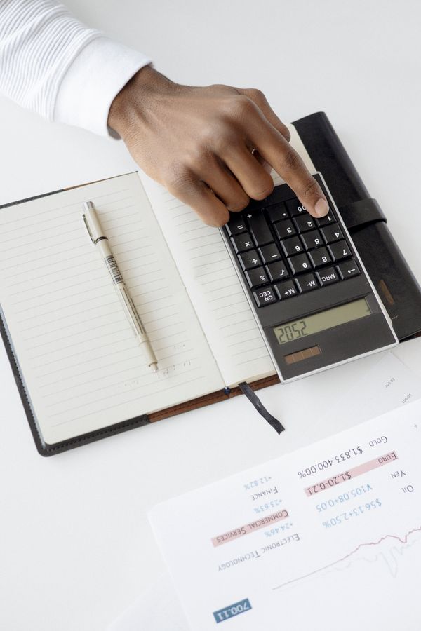 Hand calculating payroll on documents