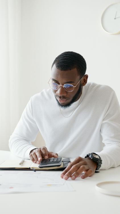 Photo Of Person Using Calculator · Free Stock Photo