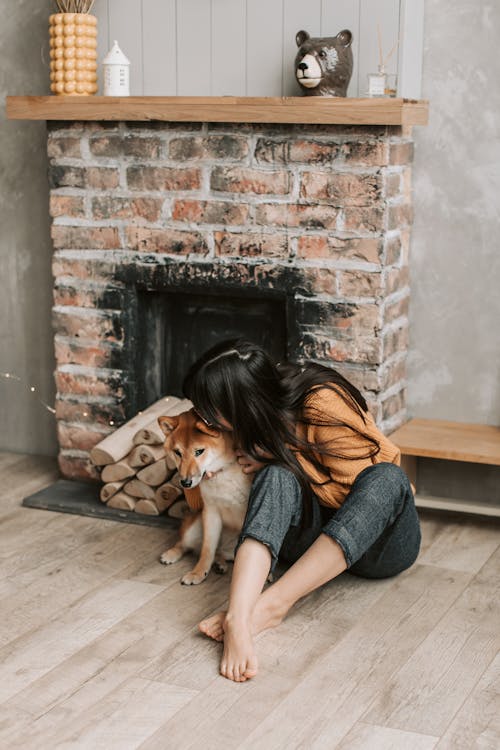 Free A Woman Sitting with Her Dog Stock Photo