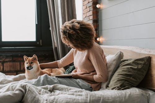 A Woman Reading a Book With Her Dog · Free Stock Photo