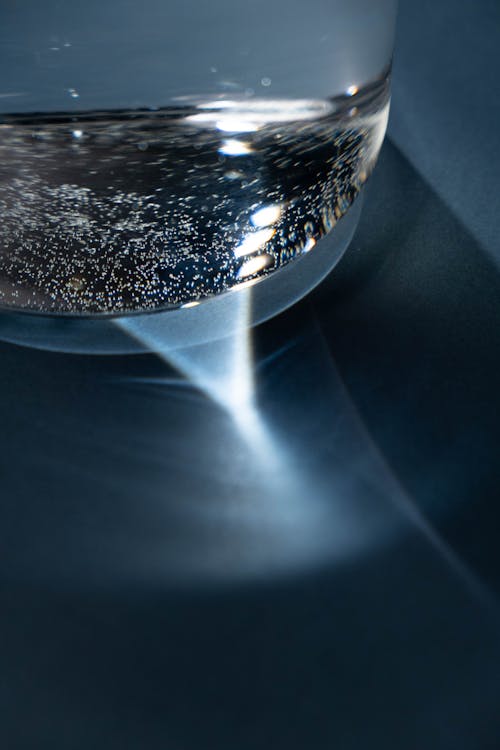 Free Clear Glass of Water with Light Reflections Stock Photo