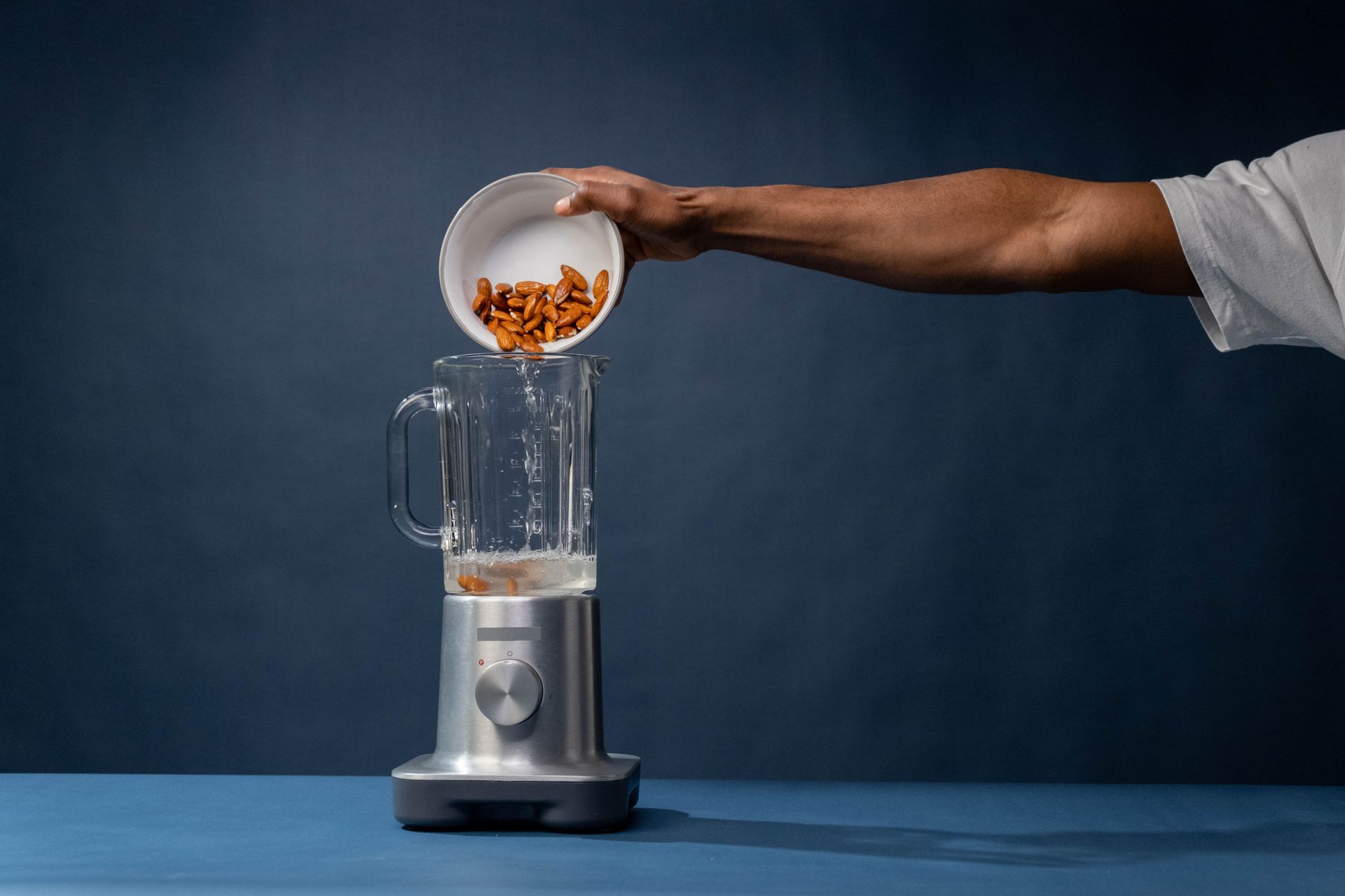 Pouring of Pecan Nuts on a Blender