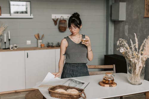 Free Woman Drinking Tea While Reading Stock Photo