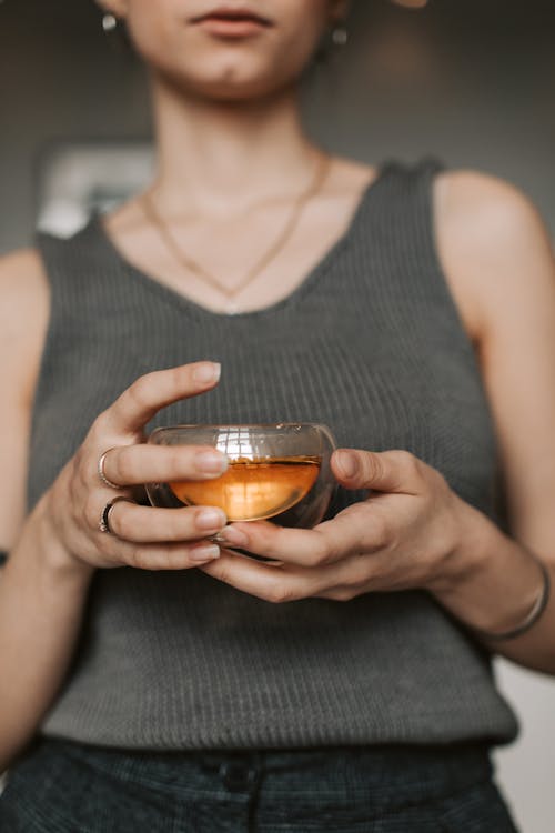 Close-up of Woman Holding a Glass with Tea 