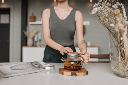 Free Woman Holding a Tea Pot  Stock Photo