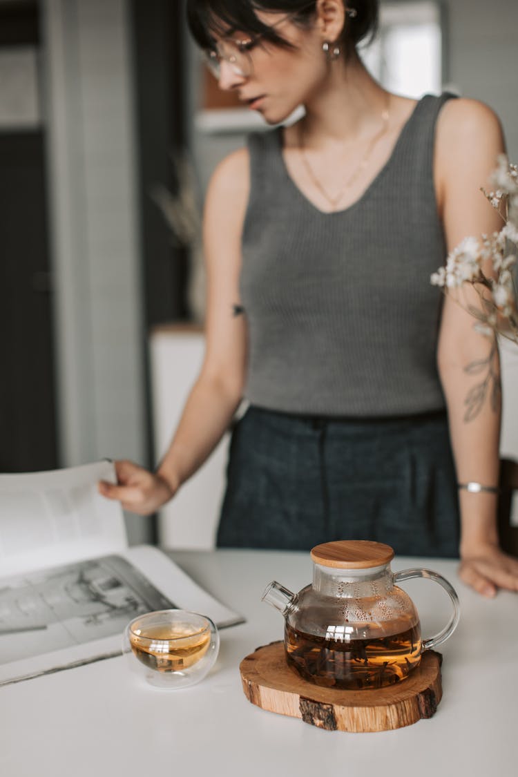 A Woman Reading A Book While Standing 