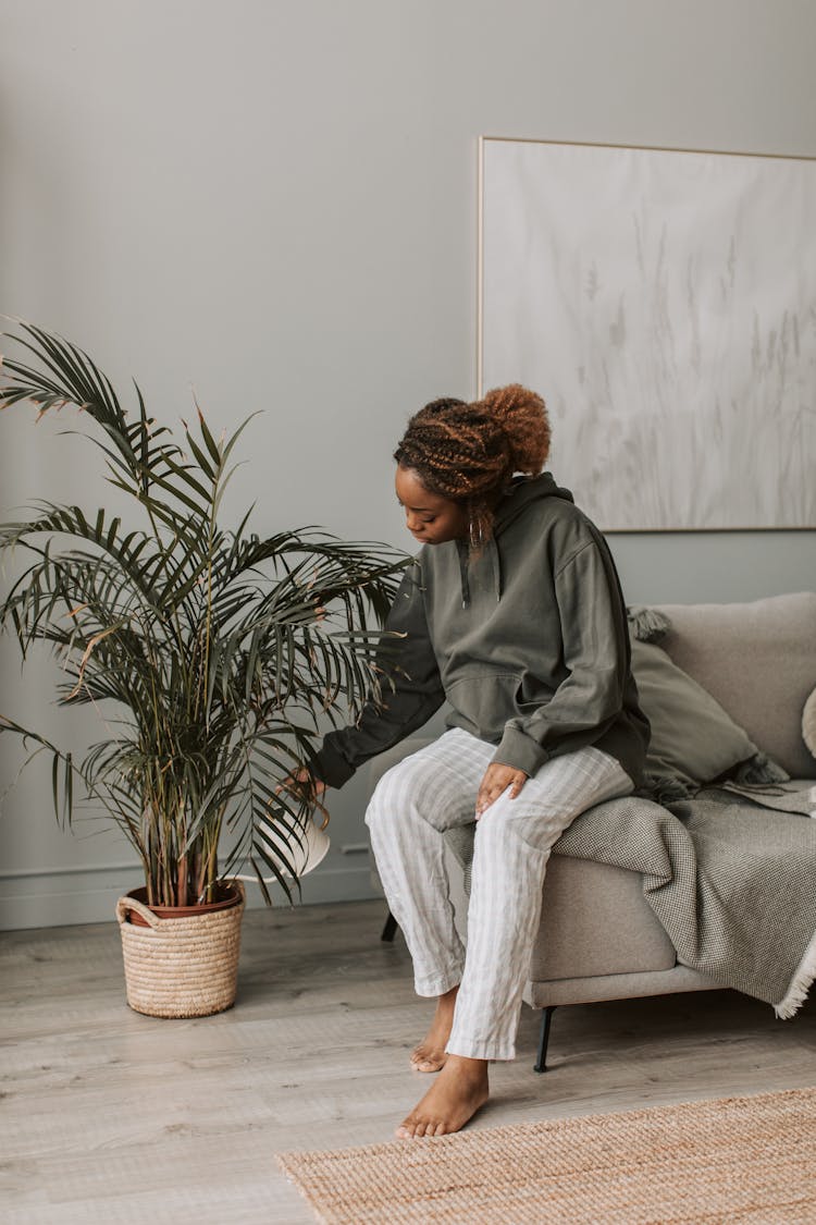 A Woman Watering Her Plant 