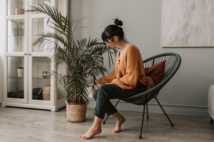 A Woman Watering A Plant 