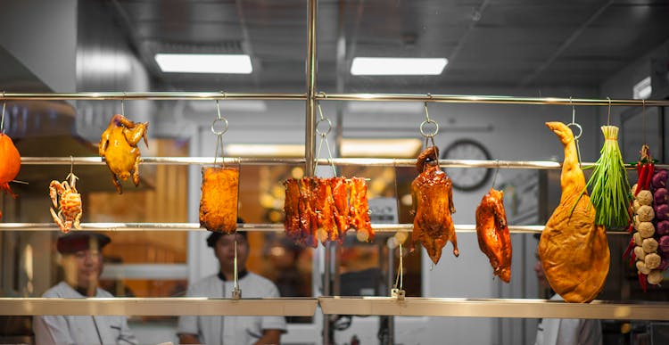 Photo Of Assorted Food Hanging On Gray Metal Railings