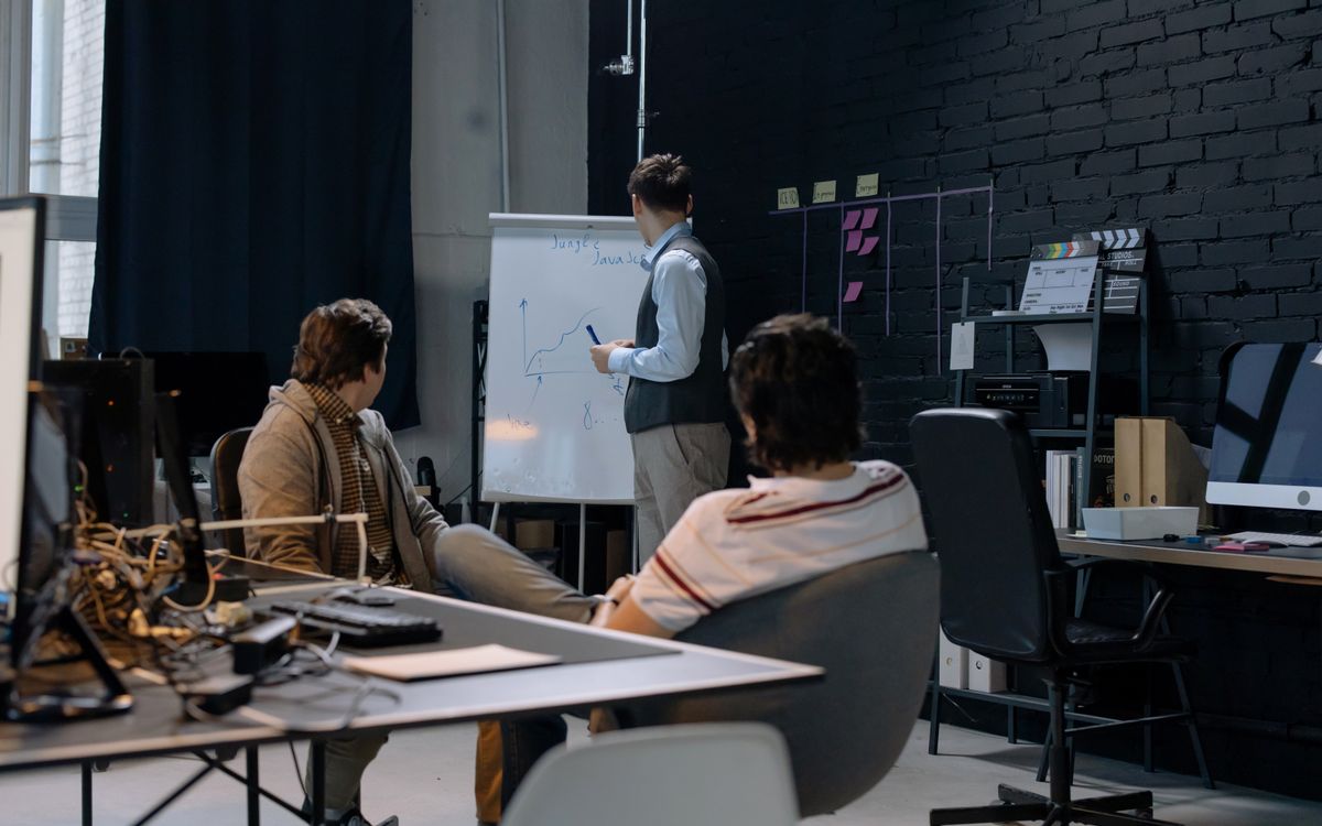 Business meeting with a presentation on growth charts in a contemporary office setting.