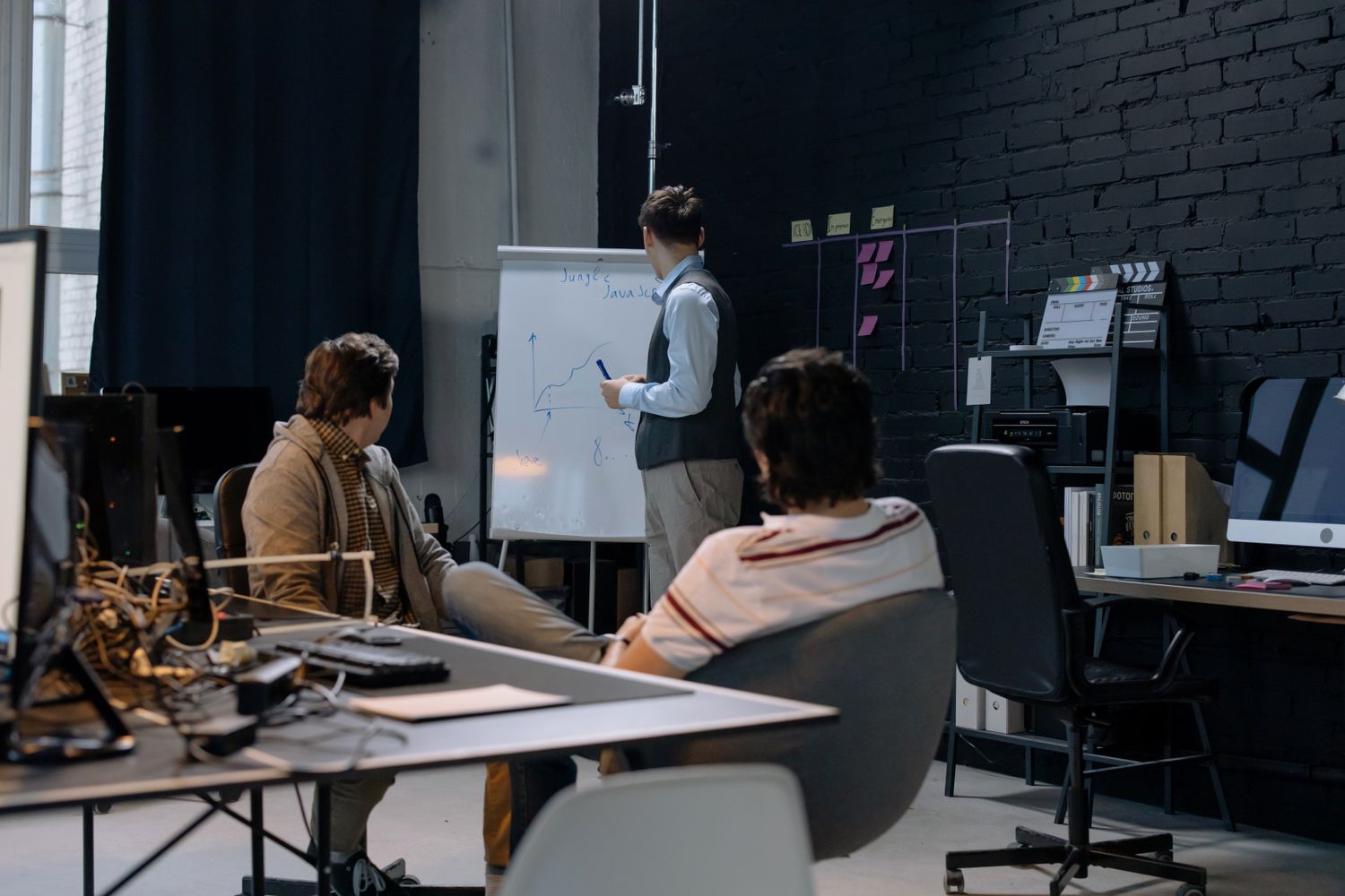Business team discussing growth and financial strategy using a presentation board