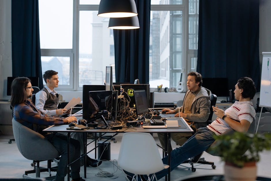 Does NordVPN Actually Block Malware Ads and Trackers? Young professionals collaborating in a vibrant office setting with computers and documents.