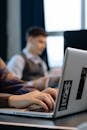 Close-up of Office Workers Sitting at the Desks and Using Computers