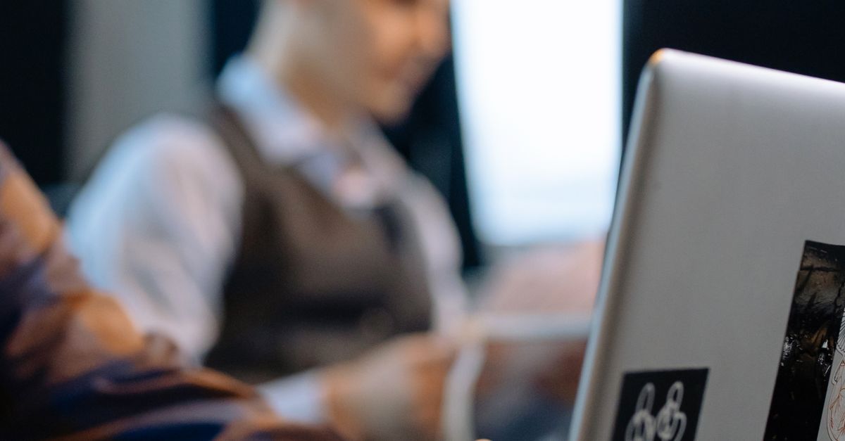 Close-up of Office Workers Sitting at the Desks and Using Computers ...