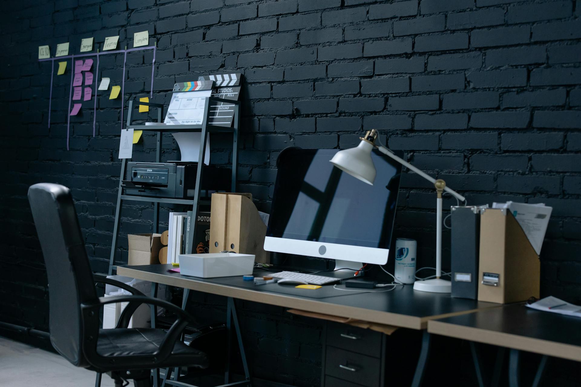 Stylish home office setup with desktop computer and organized workspace.