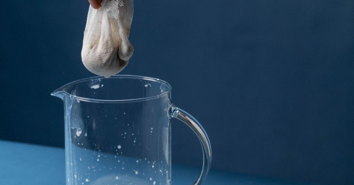 Straining Jar Close-up of Person Straining White Liquid into a Glass Jar · Free Stock ...