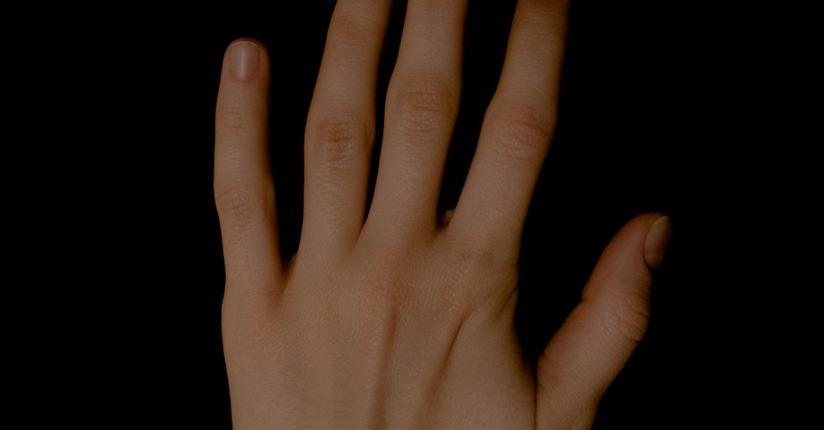 A Persons Left Hand on Black Background · Free Stock Photo