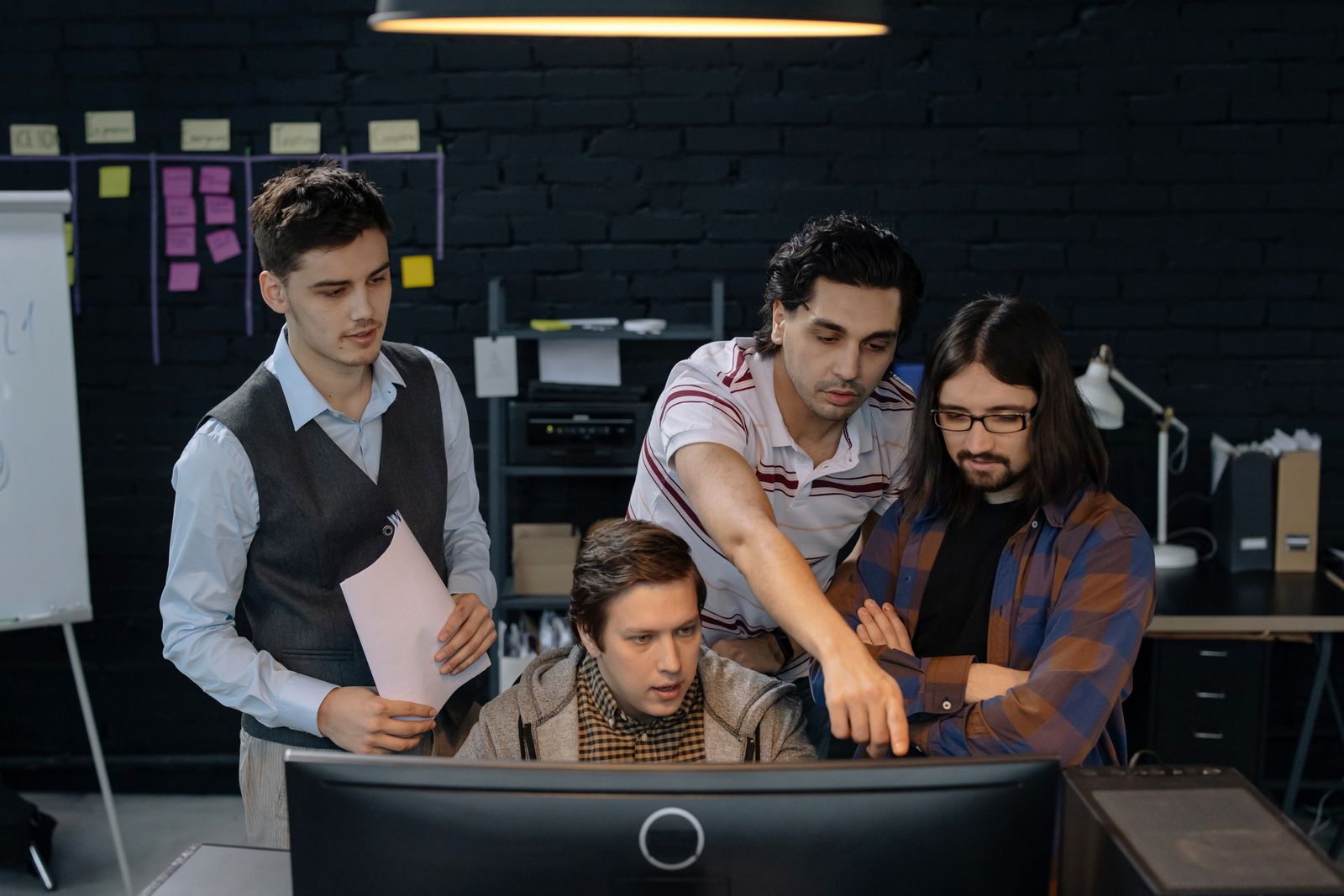 Technology team discussing a project at a computer