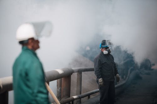 Men Wearing Gas Mask Under White Smoke