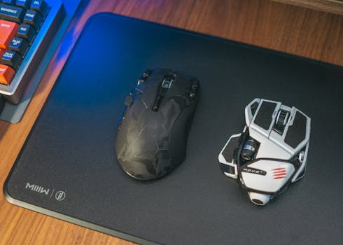Close-up of two wireless gaming mice on a desk, showcasing modern technology.