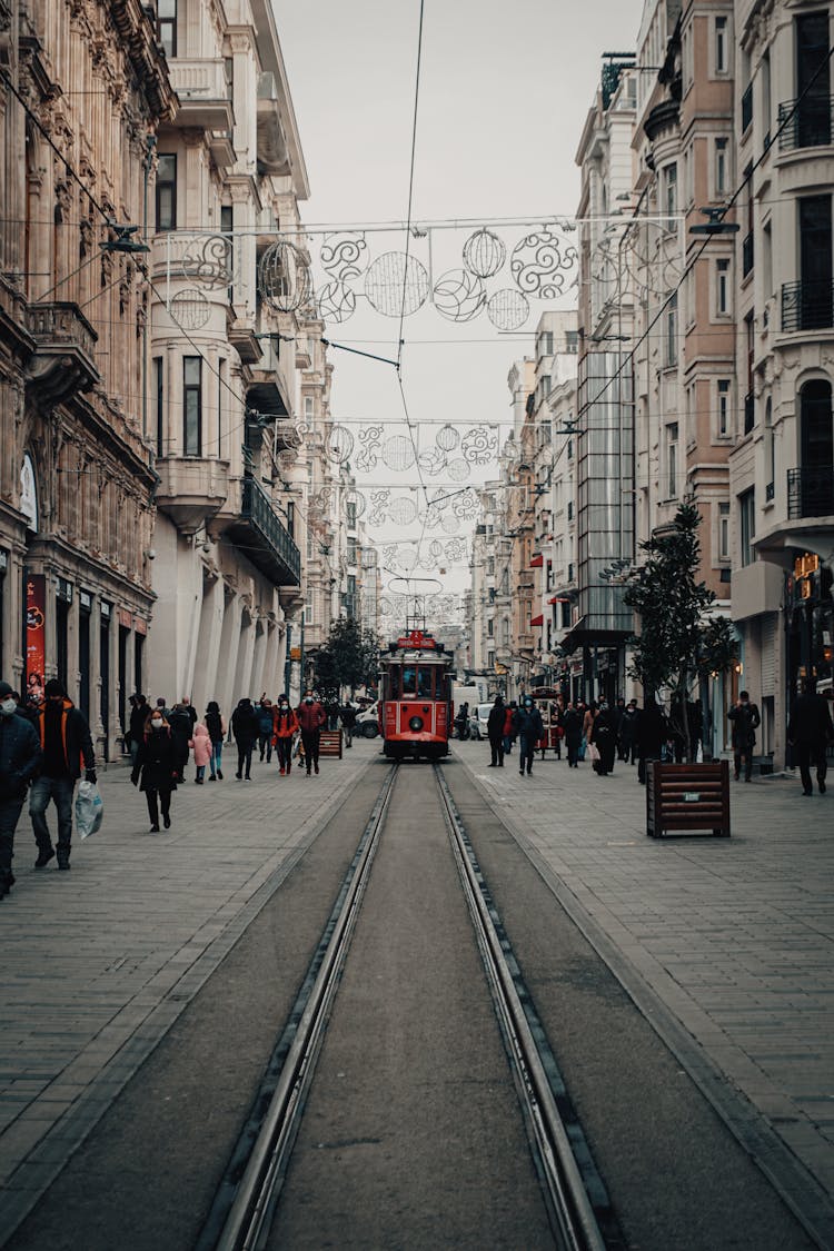 Symmetrical Shot Of A City Street Decorated With Lights For Christmas 