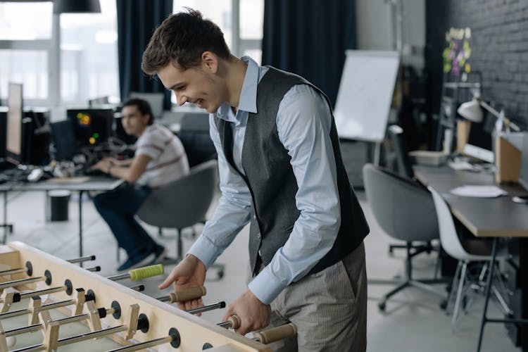 Young Employee Playing Foosball