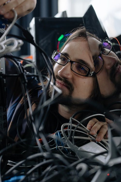 Man Fixing Cables of Computer