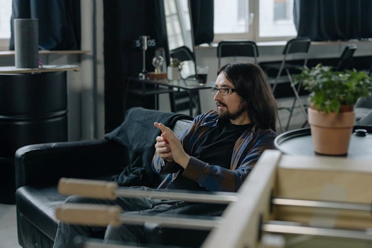 Employee Sitting On Sofa In Office