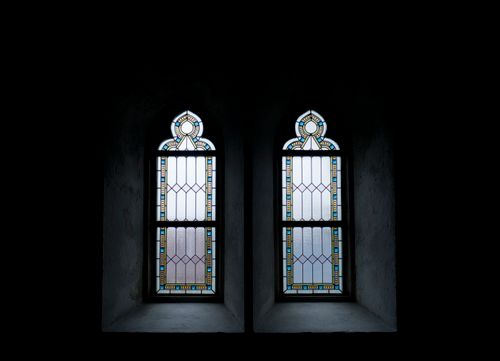 Free Gothic stained glass windows with intricate patterns, creating a serene, minimalist atmosphere. Stock Photo