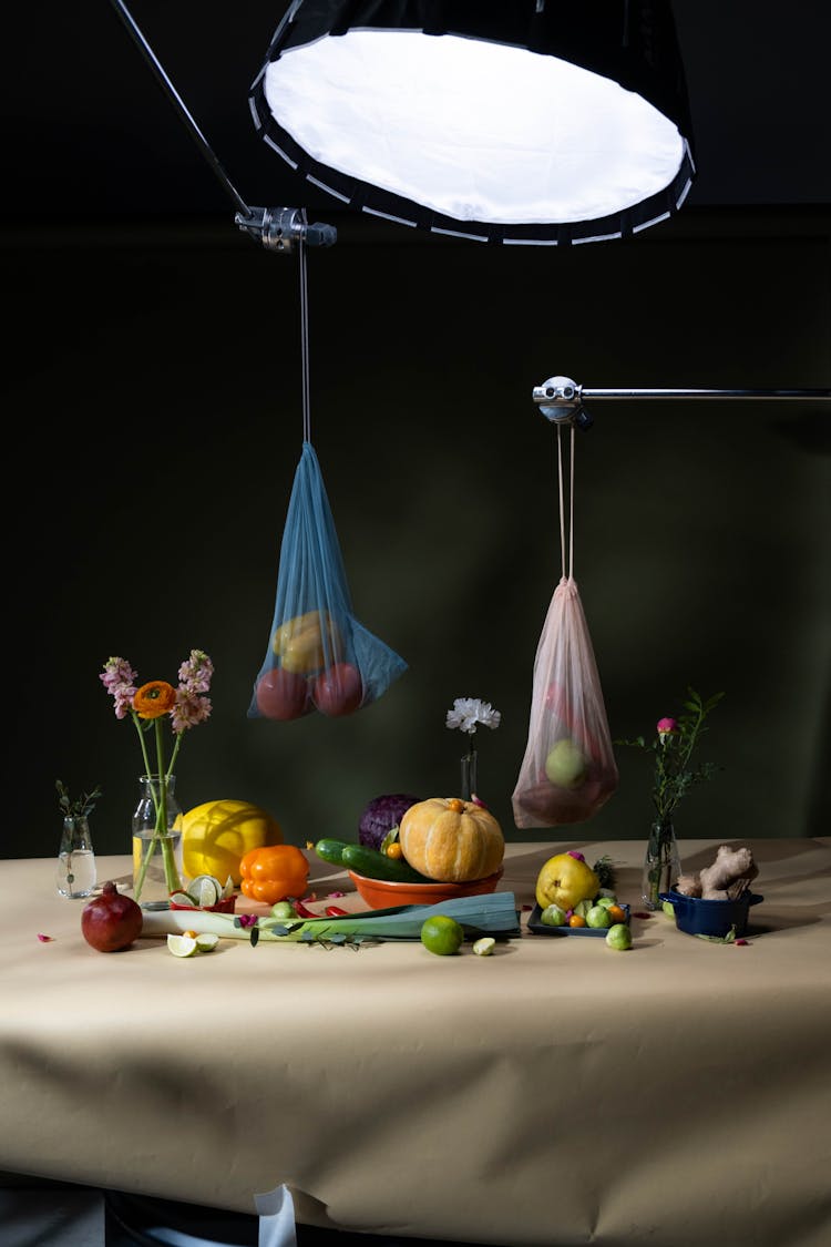 Fruits And Vegetables In Bags Hanging Over Table