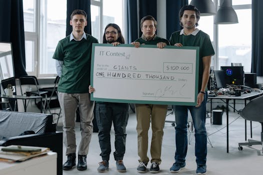 Team of programmers celebrate $100,000 IT contest victory, showcasing teamwork and innovation.