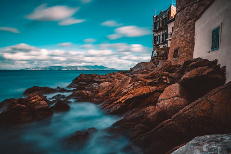 Brown Rock Shore Beside Brown Building