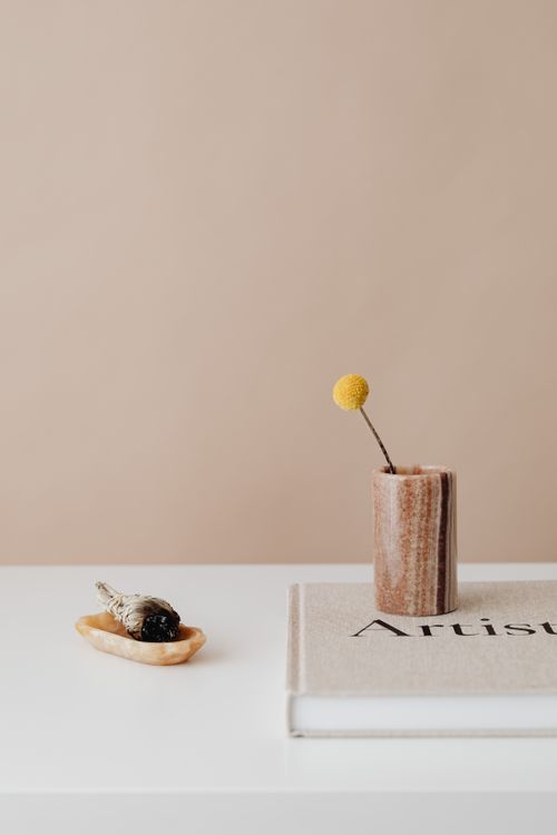 Free Aesthetic minimalism with incense, book, and flower on a table. Stock Photo