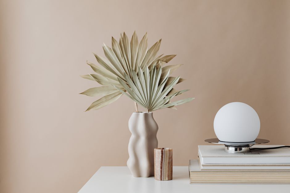 A minimalist aesthetic desk with a journal showing a hand-written name in calligraphy