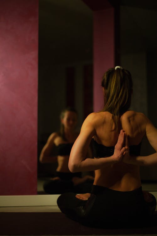 Free Woman Meditating in Yoga Position Stock Photo