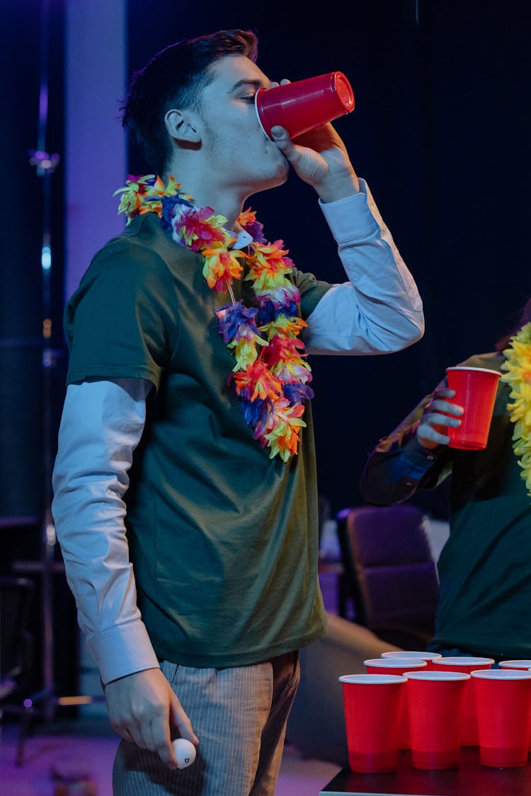 Man Drinking From A Red Cup