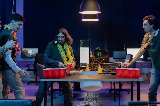 A group of men enjoying a lively beer pong game indoors with vibrant decor and red cups.