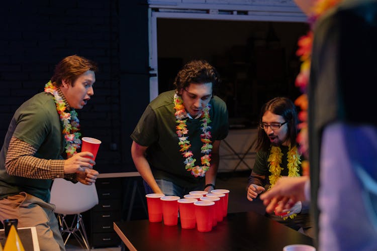 Colleagues Playing Beer Pong At A Company Party In The Office