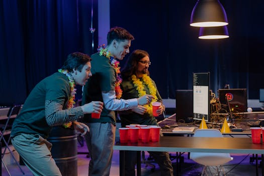 Group of male colleagues enjoying a fun beer pong game during an office party night.