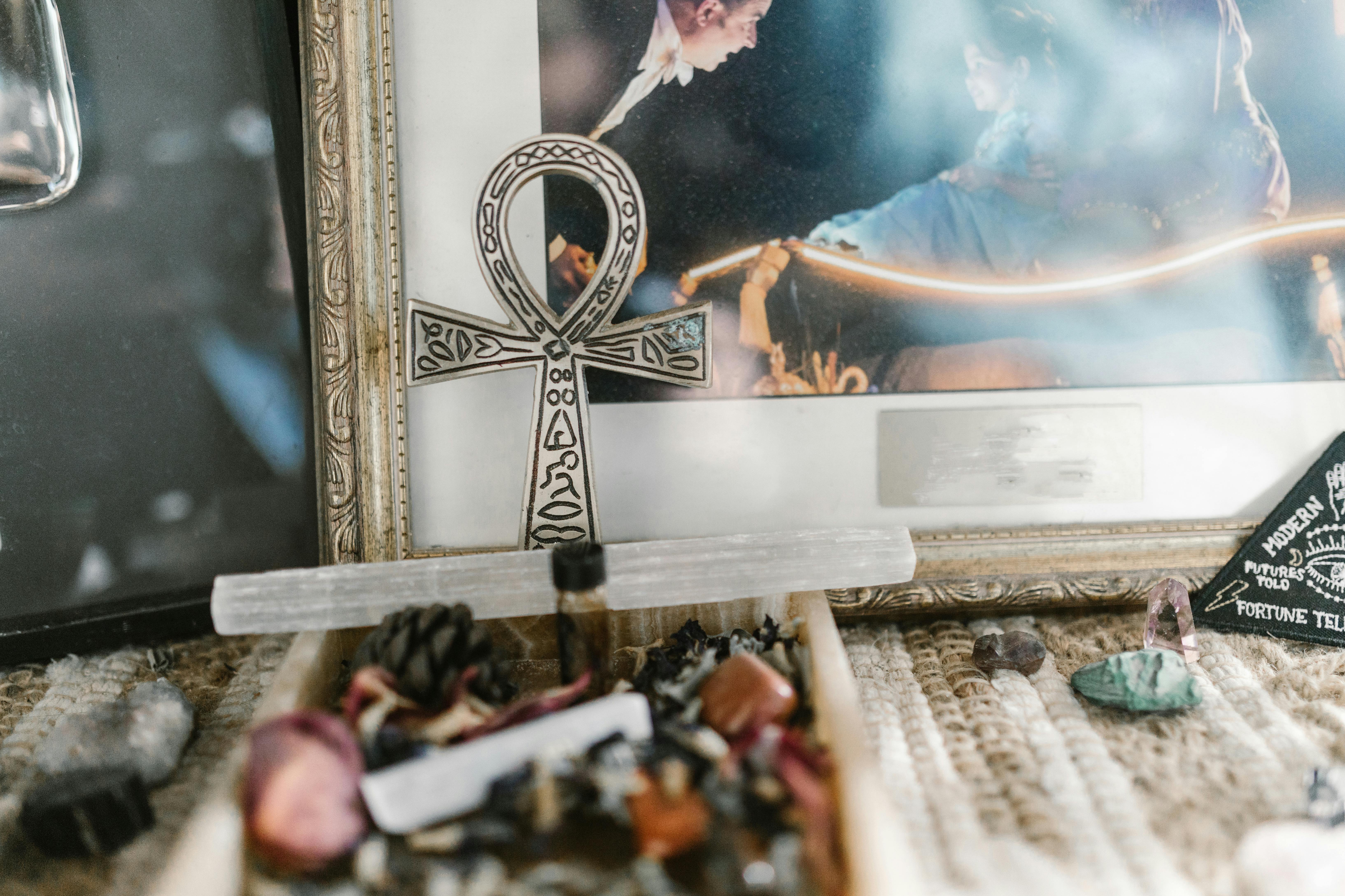 A mystical arrangement featuring an Ankh symbol with various crystals, depicting a spiritual ambiance.