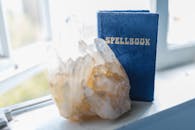 A Spell Book and Gem Stone on the Window Seal