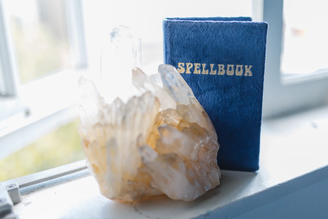 Free A Spell Book and Gem Stone on the Window Seal Stock Photo